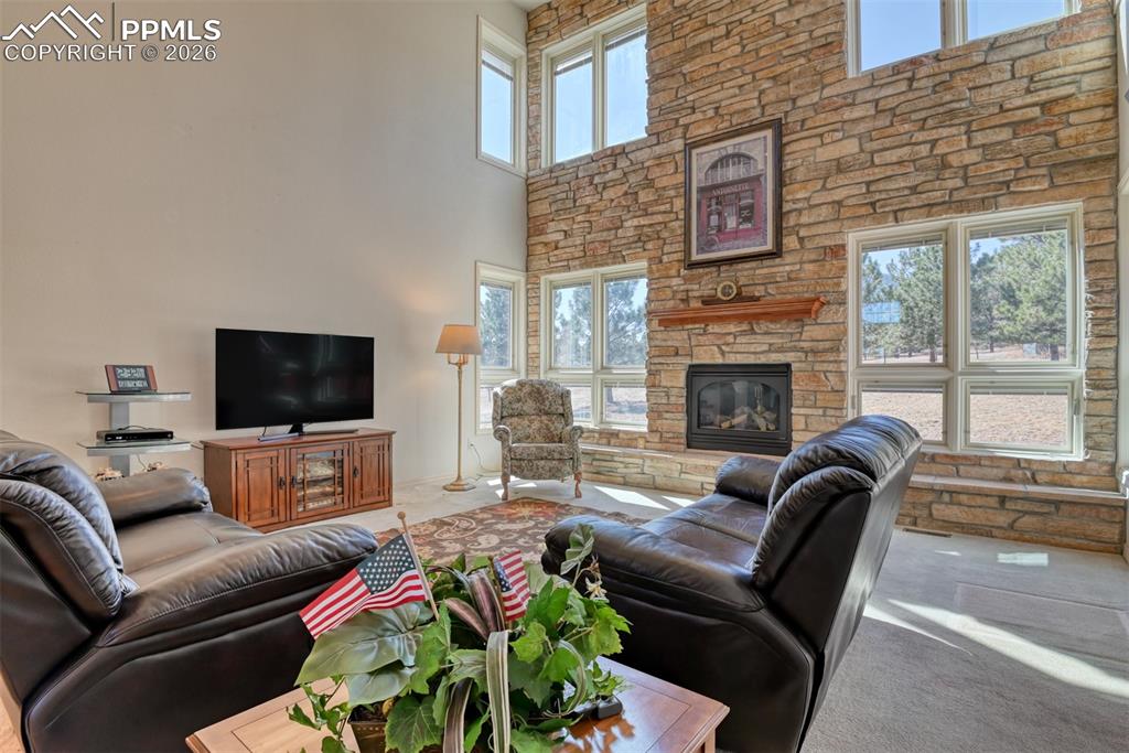 Great room features a stone wall with gas fireplace