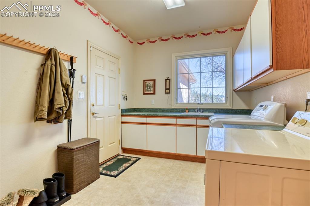 Laundry room with sink with door leading to the 3-car garage. 