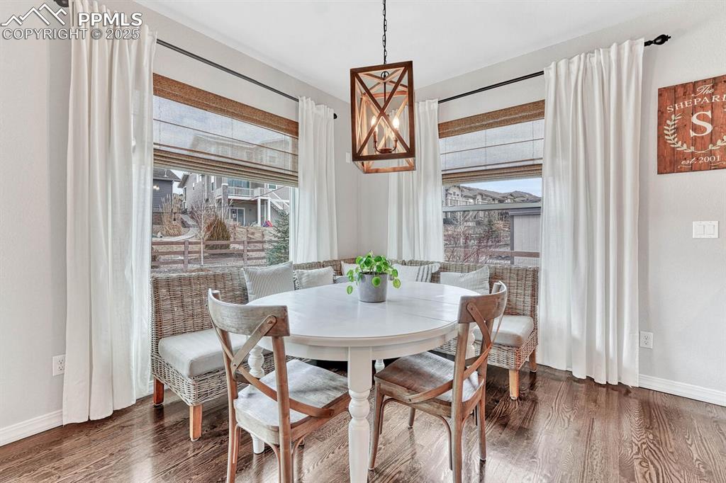 Dining space featuring wood finished floors and baseboards
