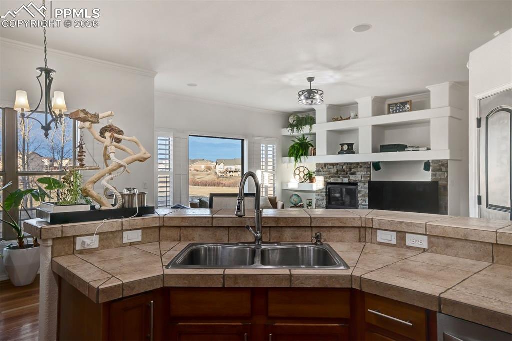 Sink overlooking the dining room and living room. To the right is a second walk-in pantry