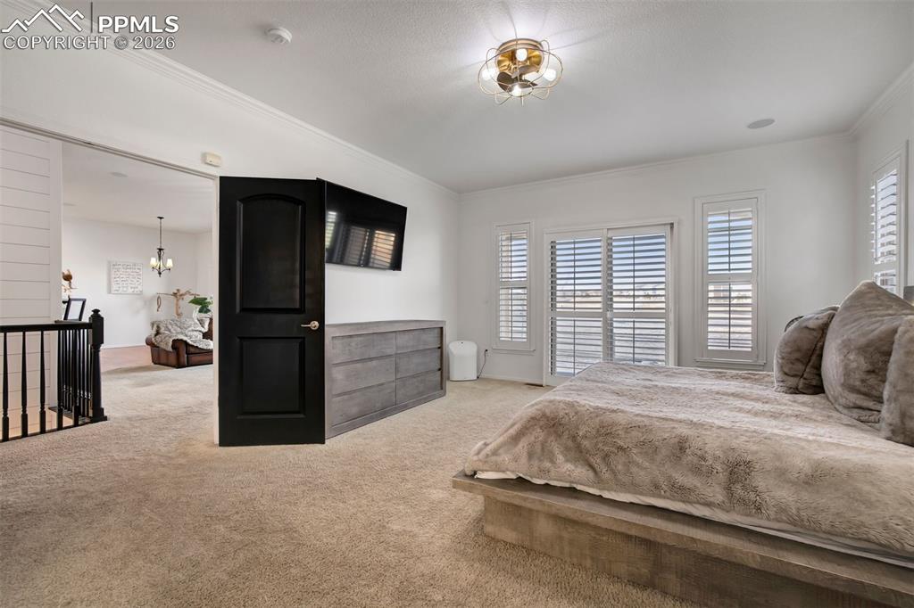Double doors leading to the primary bedroom. Sliding glass door from the bedroom to the back patio