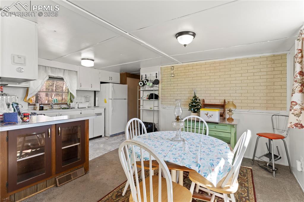 Dining space featuring light colored carpet