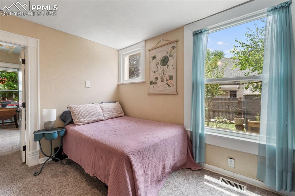 Bedroom featuring carpet flooring and baseboards