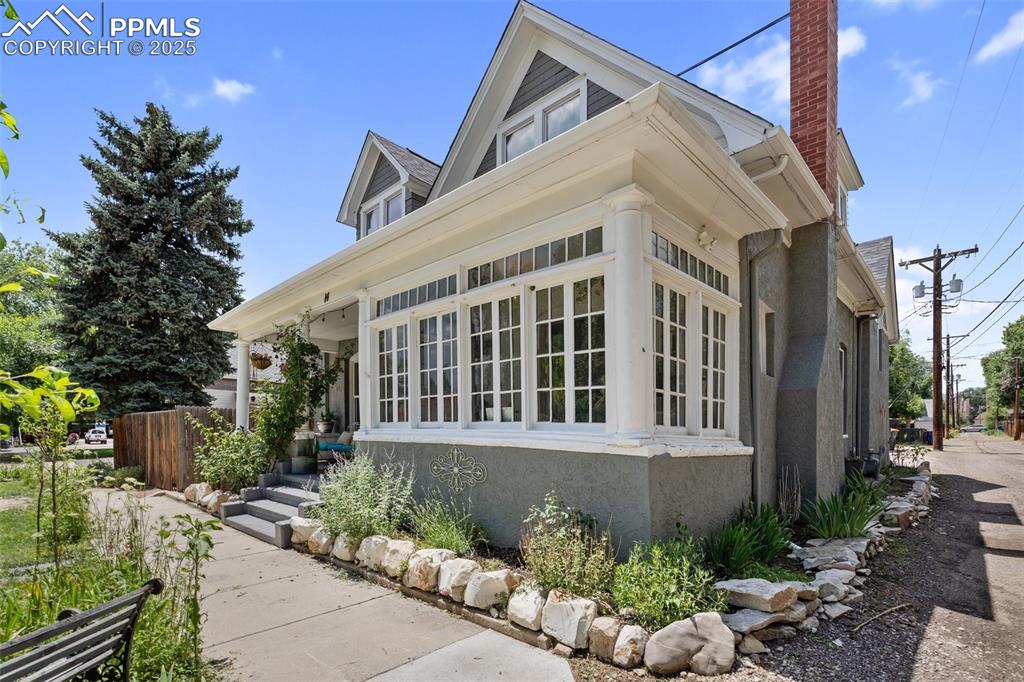 View of side of home featuring a chimney