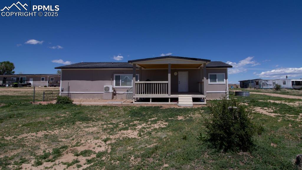 3425 Wiesner - Back of house with a lawn and a cooling unit