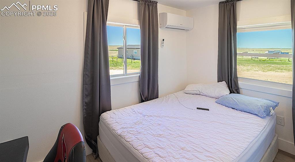 Bedroom with a wall mounted AC