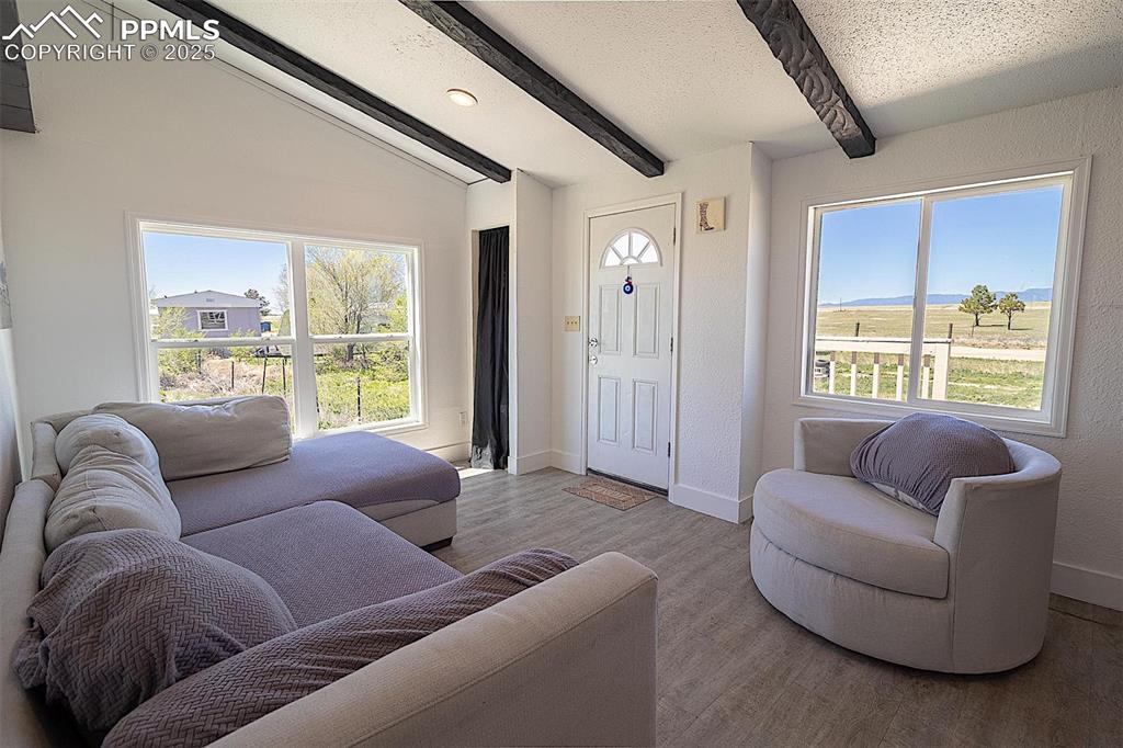 Living area featuring baseboards and wood finished floors