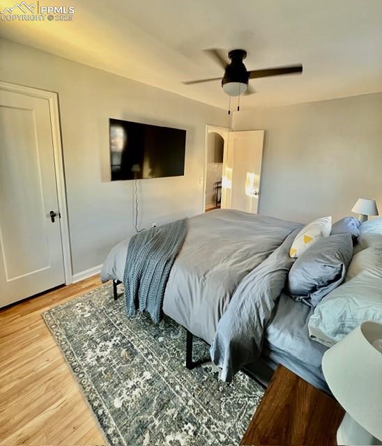 Bedroom featuring ceiling fan and light wood flooring