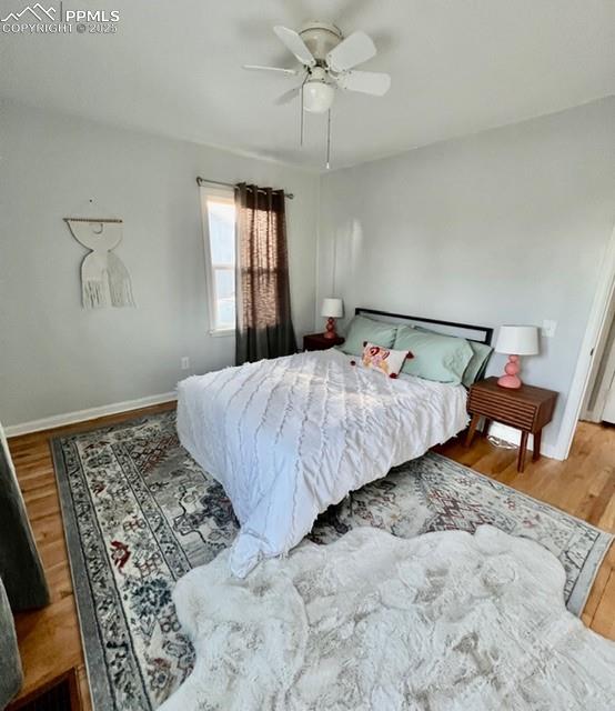 Bedroom featuring wood finished floors and a ceiling fan