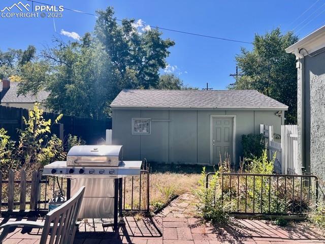 View of patio / terrace featuring area for grilling and an outbuilding