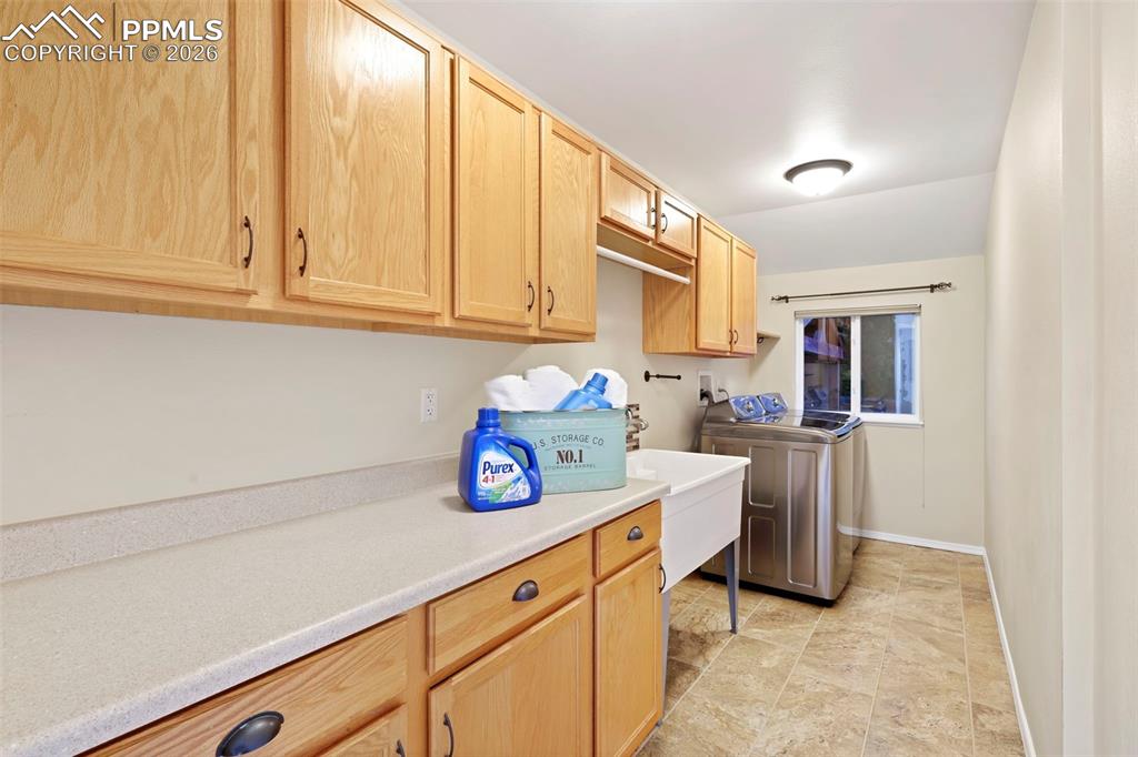 Laundry area featuring cabinet space and independent washer and dryer