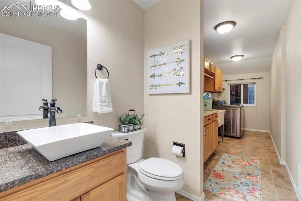 Bathroom with vanity and washer and dryer