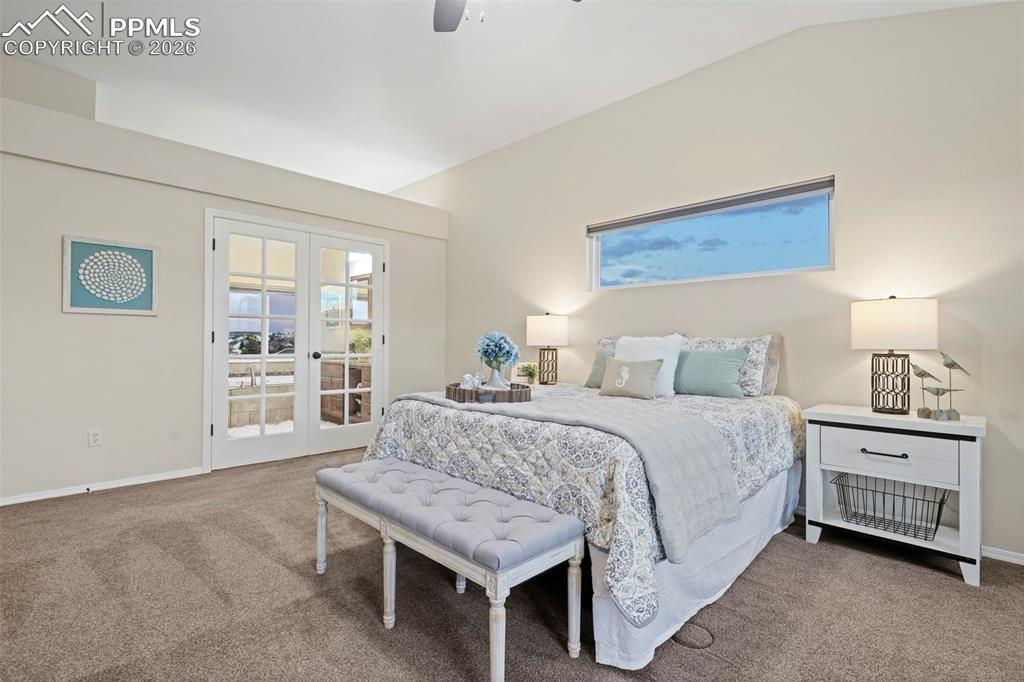 Bedroom featuring access to outside, french doors, carpet flooring, and vaulted ceiling
