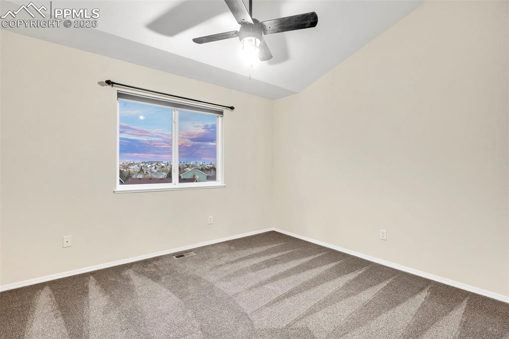 Unfurnished bedroom with carpet flooring and a ceiling fan