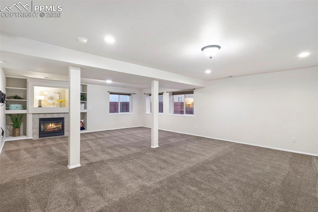 Below grade area with a fireplace, carpet flooring, and recessed lighting