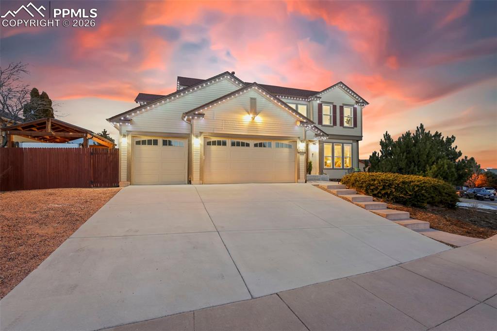 View of front of property with an attached garage and concrete driveway