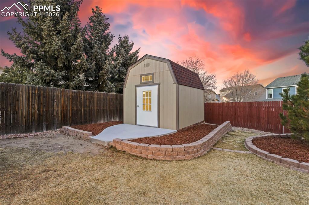 View of shed with a fenced backyard