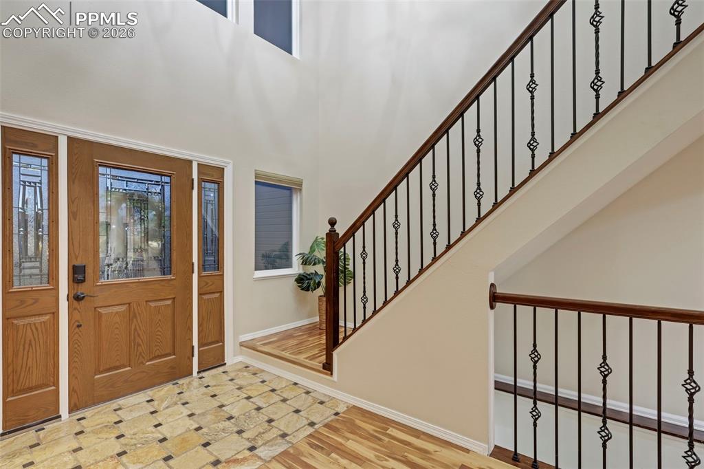 Entrance foyer featuring wood finished floors and a high ceiling