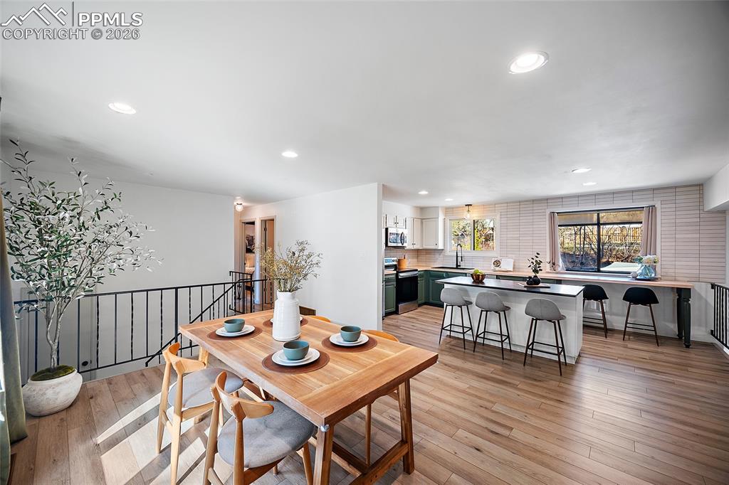 Dining space featuring light wood finished floors and recessed lighting