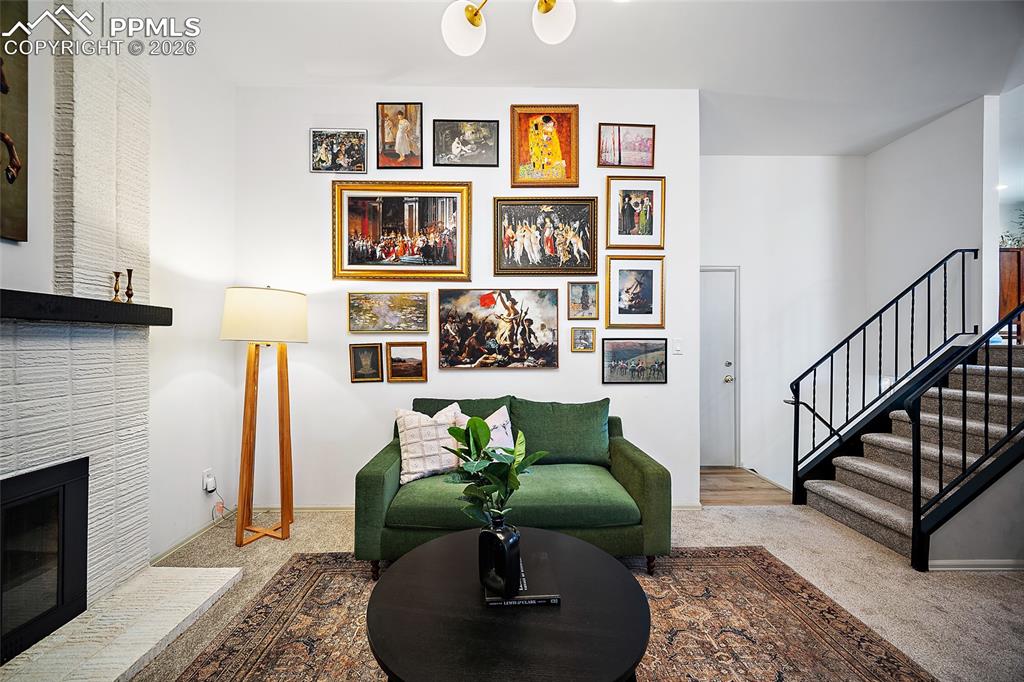 Sitting room with a tile fireplace and carpet