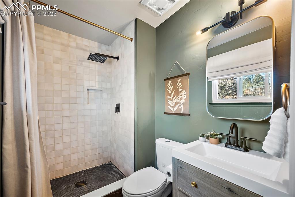 Primary bathroom with vanity and a stall shower