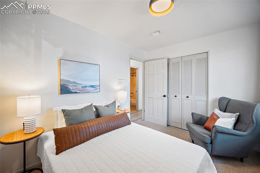 Bedroom with a closet and light colored carpet
