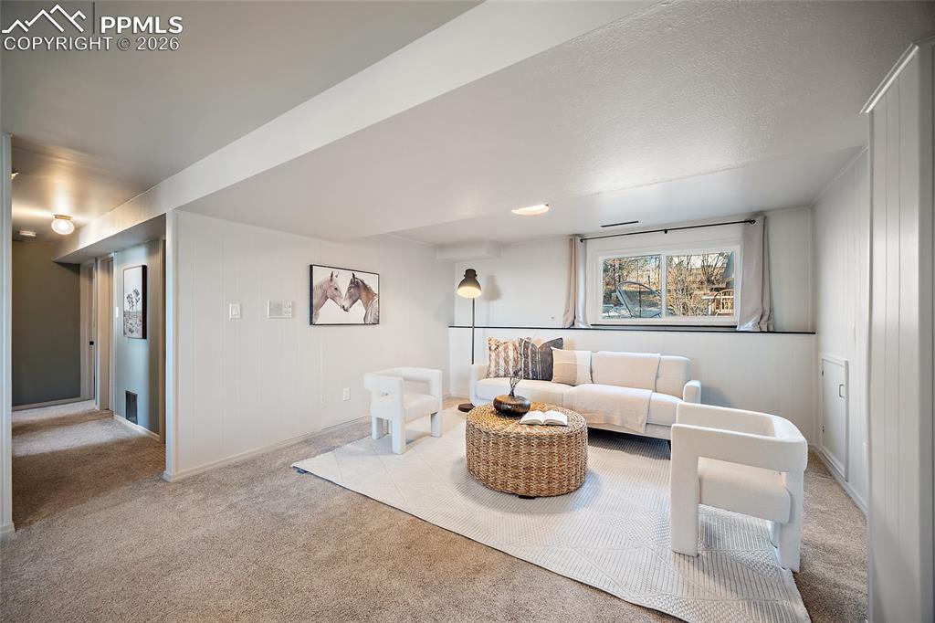 Carpeted living area with baseboards