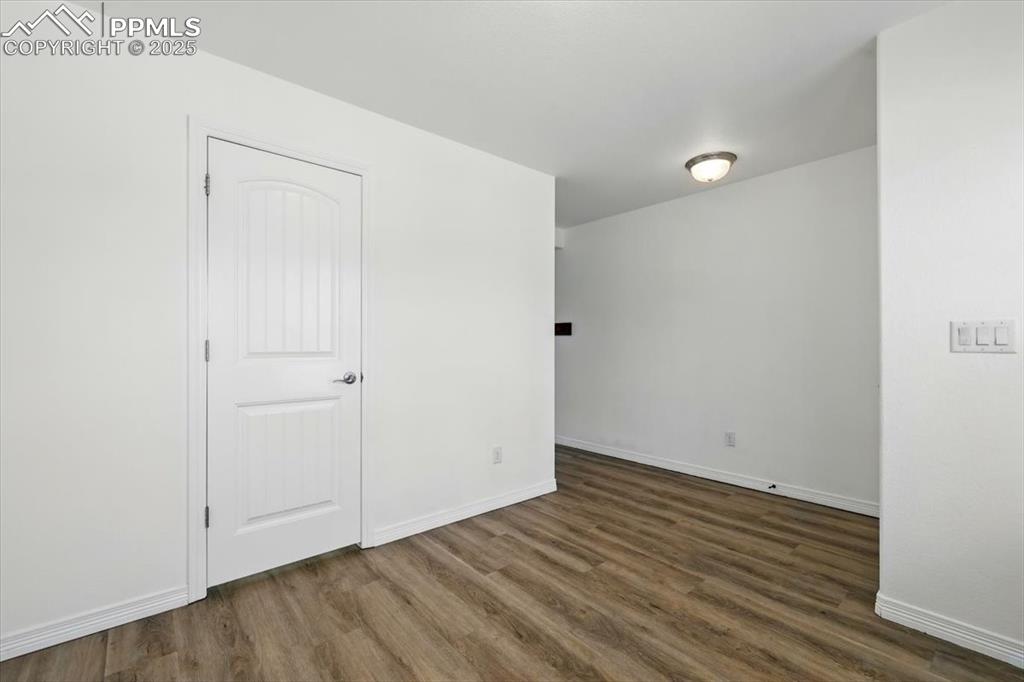 Empty room with wood finished floors and baseboards