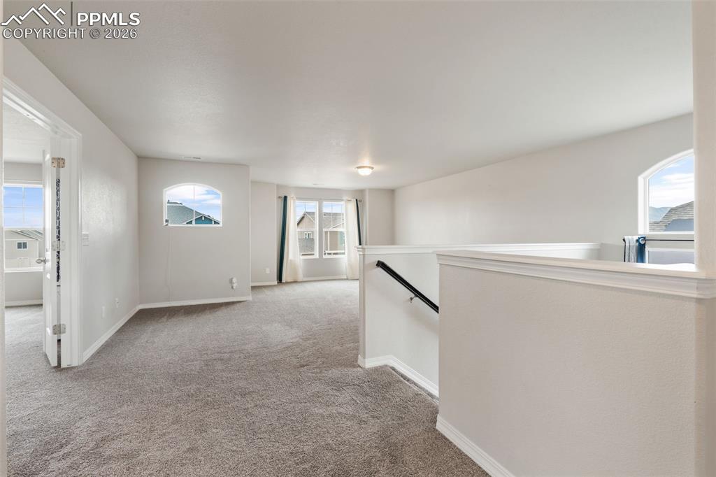Unfurnished room with carpet and baseboards