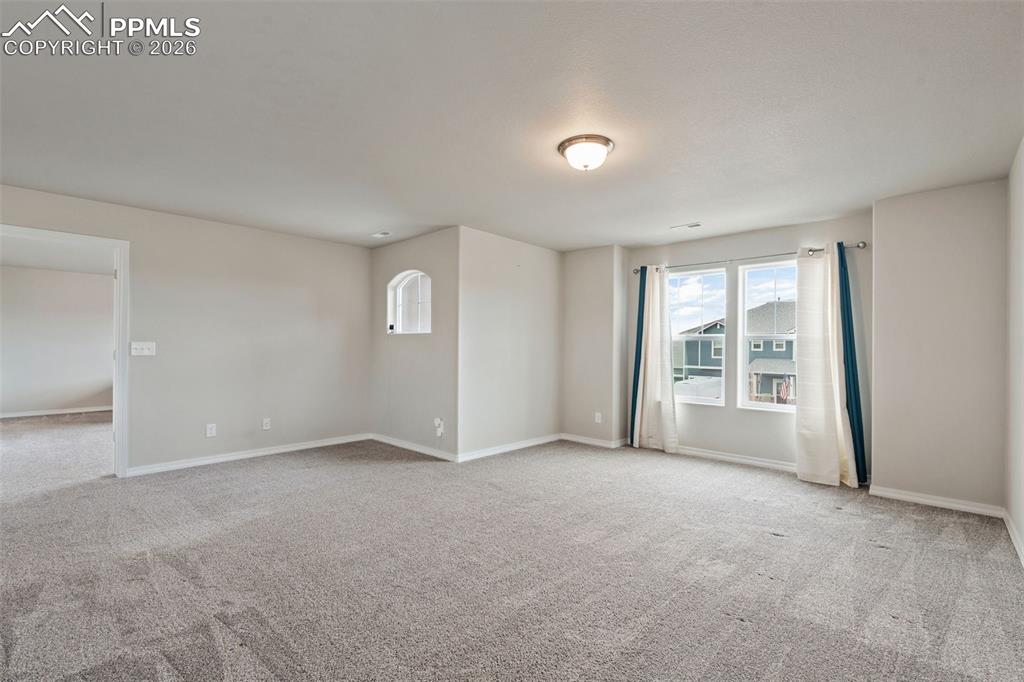 Spare room featuring light colored carpet