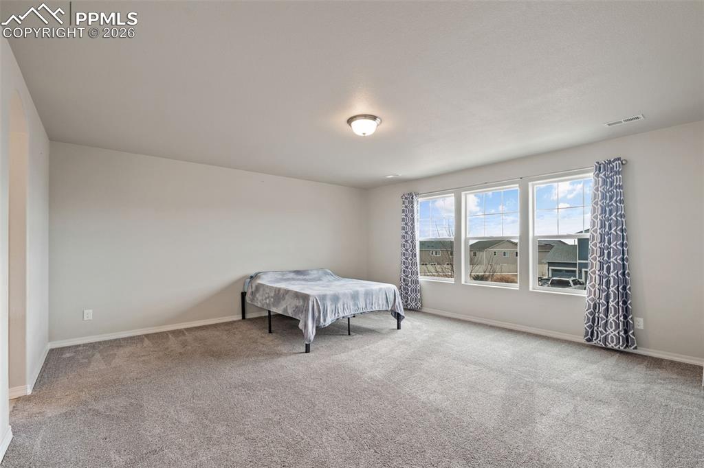 Carpeted bedroom with baseboards