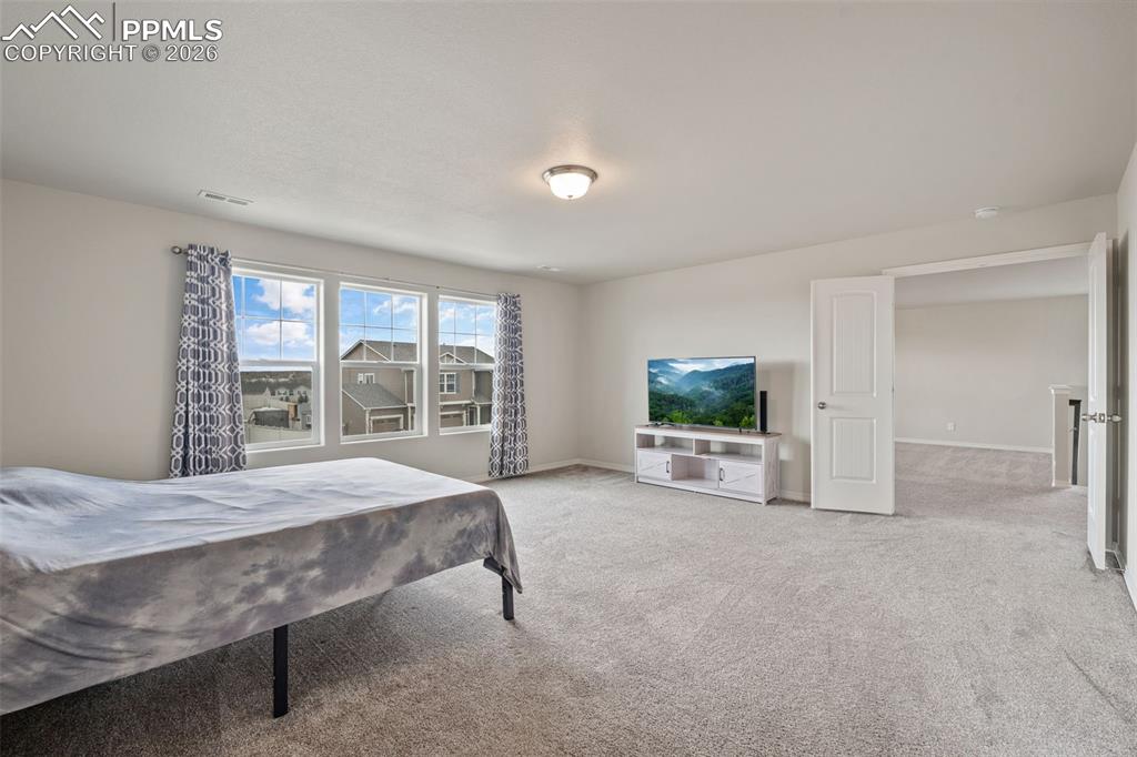 Carpeted bedroom featuring baseboards