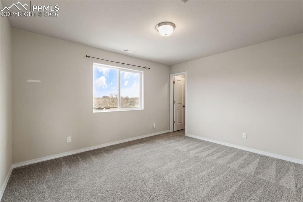 Spare room with baseboards and carpet floors