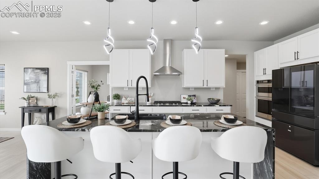 The chef's Kitchen boasts stainless steel appliances (5-burner gas cooktop, built-in oven, microwave, dishwasher, SMART Samsung fridge), walk-in pantry & ample cabinetry.