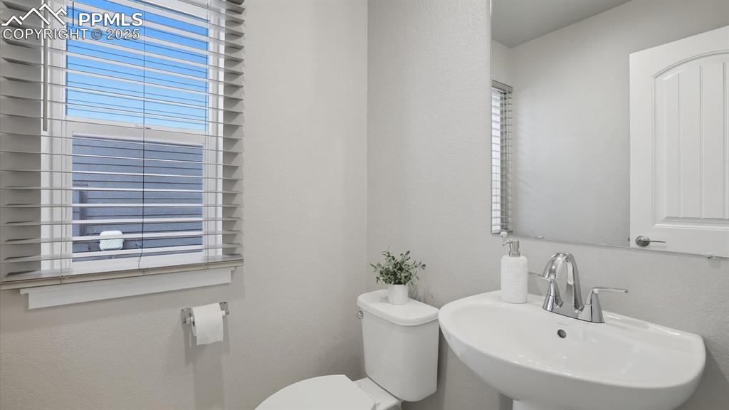 Main level Powder Bathroom with pedestal sink.