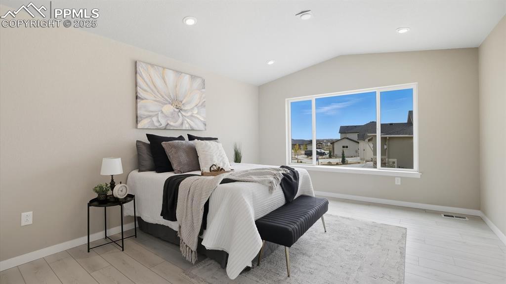 Vaulted Main level Primary Suite with neutral carpet, adjoining 5-piece Bathroom, and walk in closet.