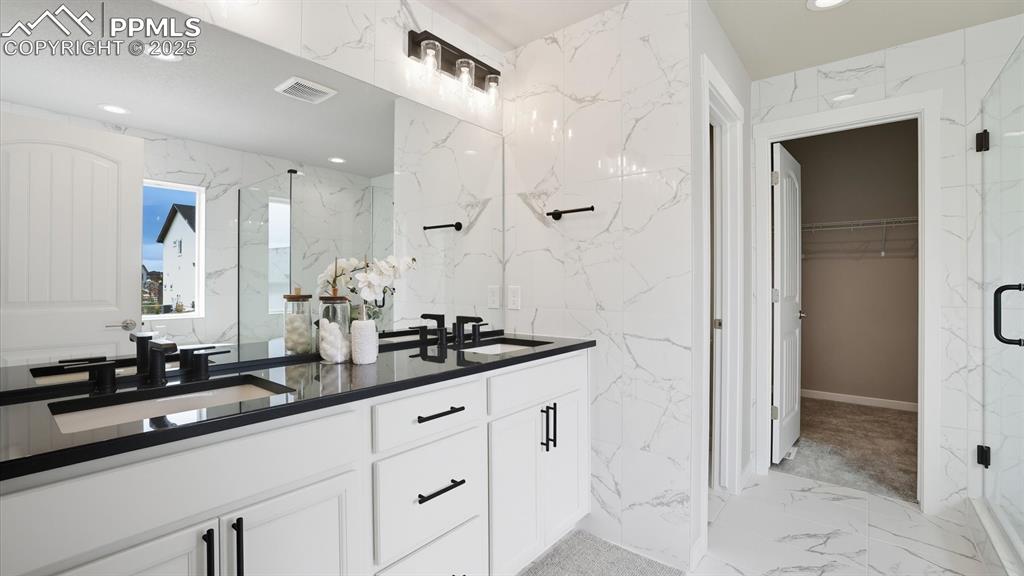5-piece Primary Bathroom with dual sink vanity with quartz countertops, soaking tub, and tiled shower.
