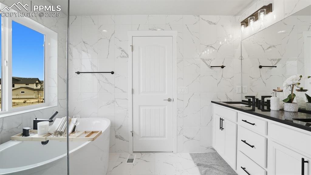 Gorgeous tiled walls to the ceiling in the Primary Bathroom.