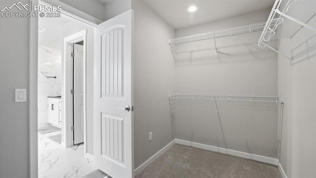 Walk in closet in the Primary Suite.