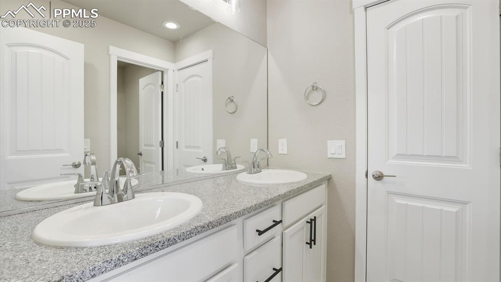 Dual sink vanity with quartz countertops in the Front Bathroom.