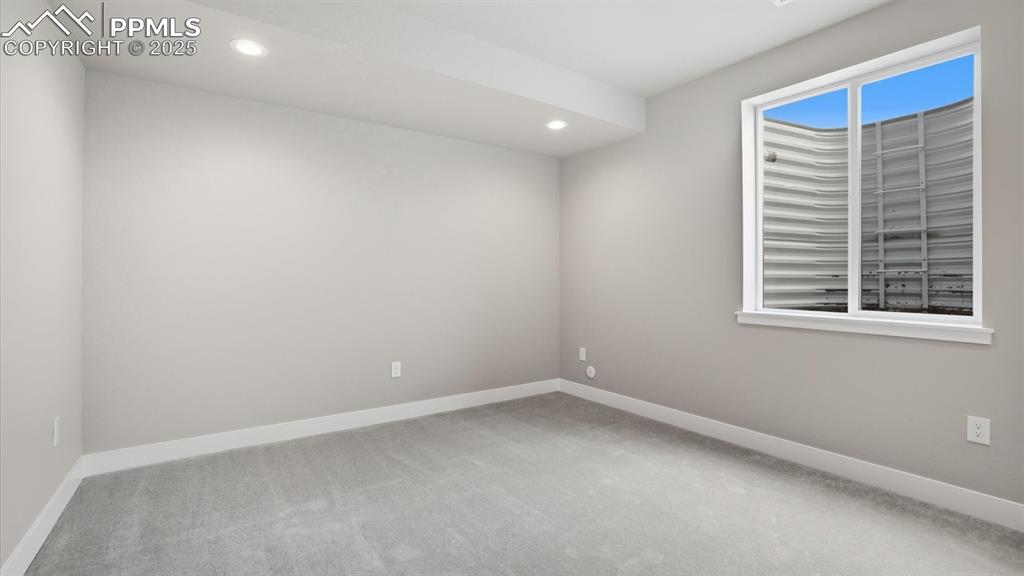 Basement Bedroom #4 with neutral carpet.