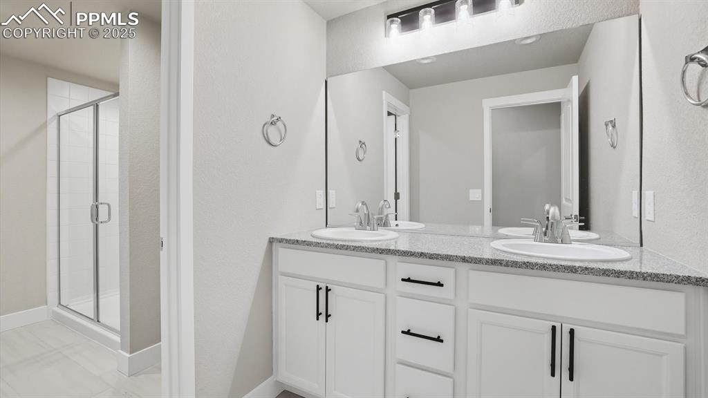 Double sink vanity with quartz countertops in Basement Bathroom.