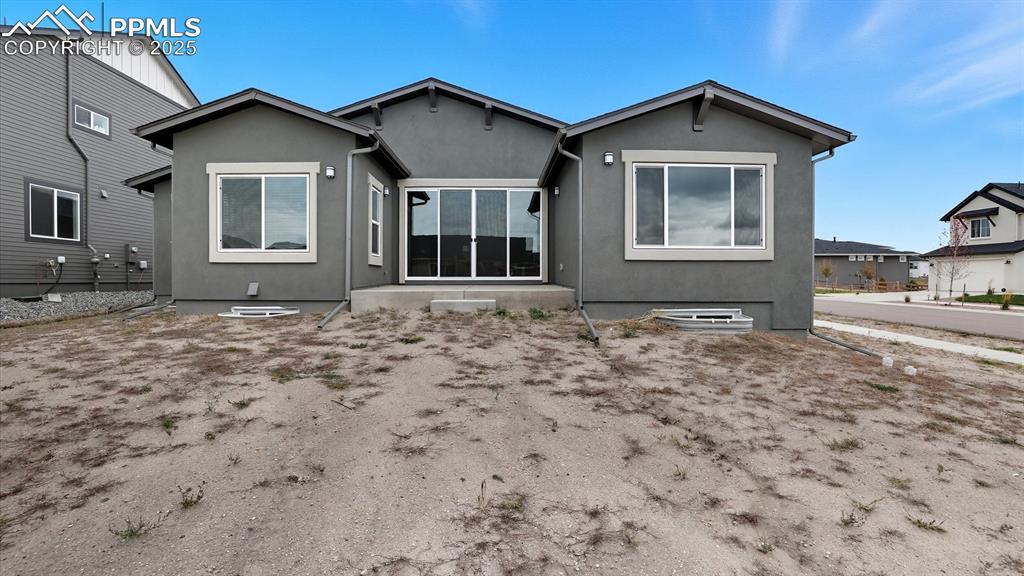 Rear view of home and 0.27 acre corner lot.