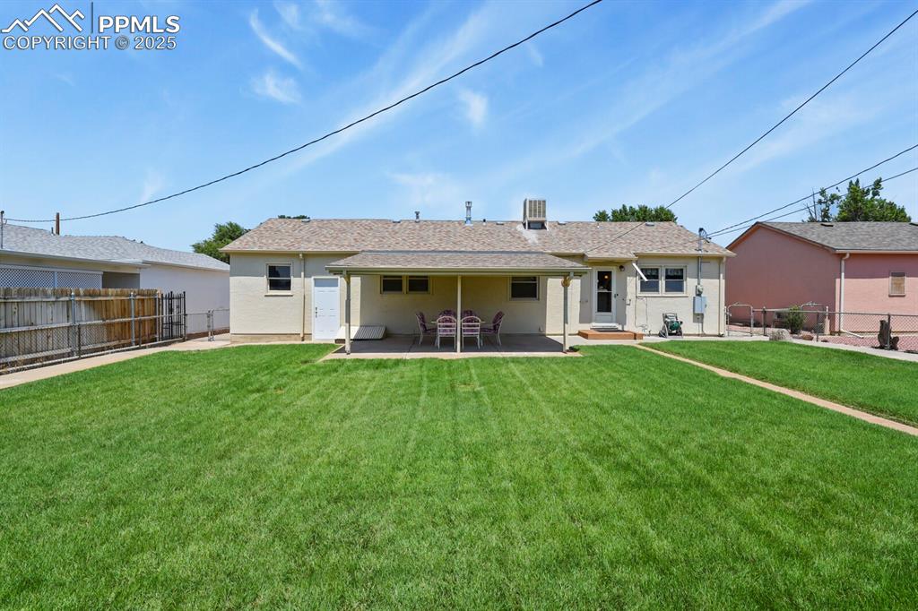 Rear view of house with a patio area and a fenced backyard