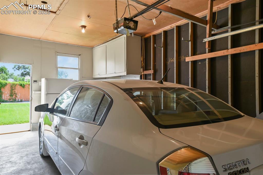 Garage featuring a garage door opener