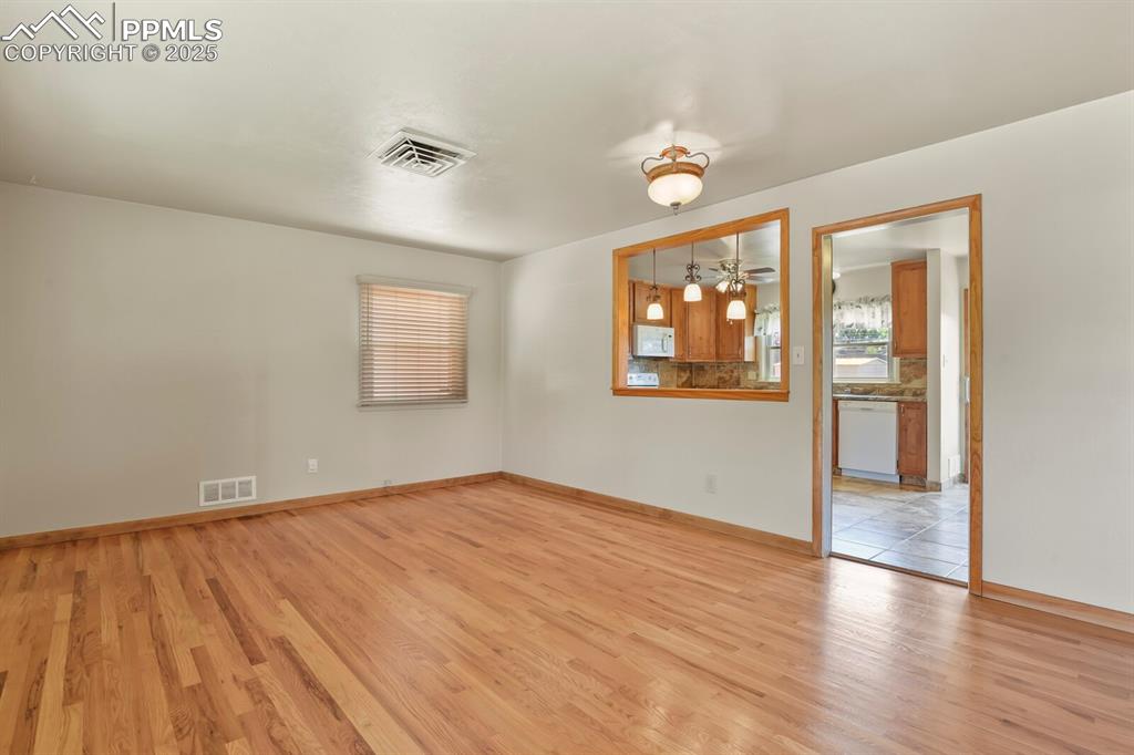 Family/living room with light wood finished floors and pass through to kitchen