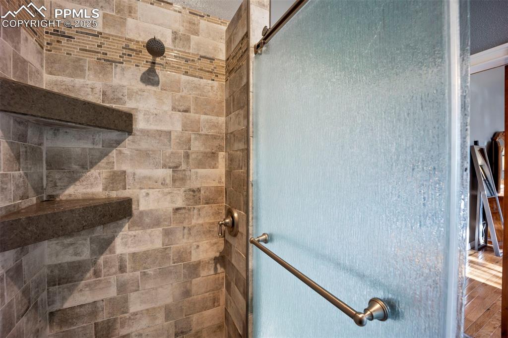 Room details featuring a stall shower