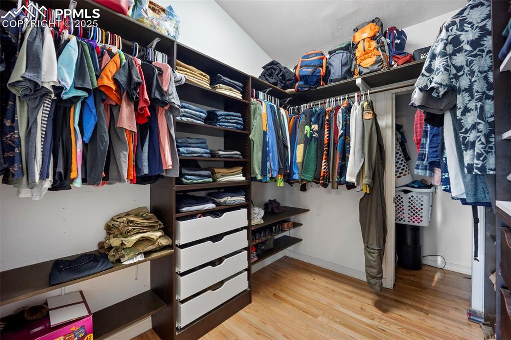 Spacious closet with wood finished floors