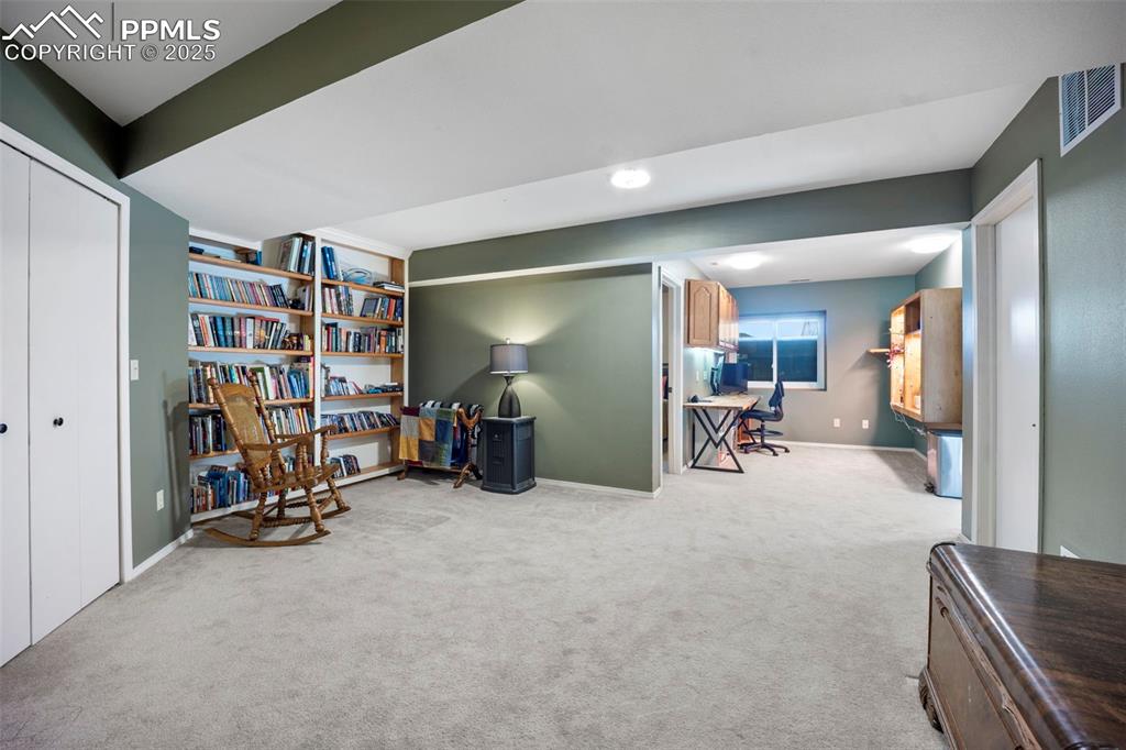 Sitting room featuring baseboards, visible vents, and carpet floors