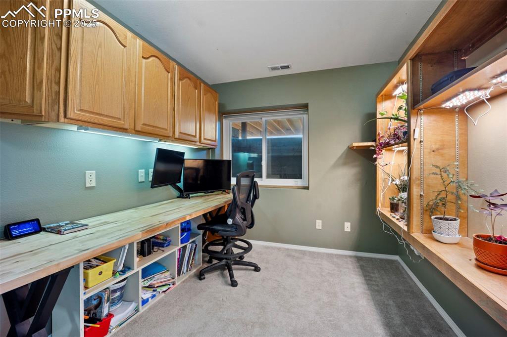 Office with visible vents, carpet, and baseboards